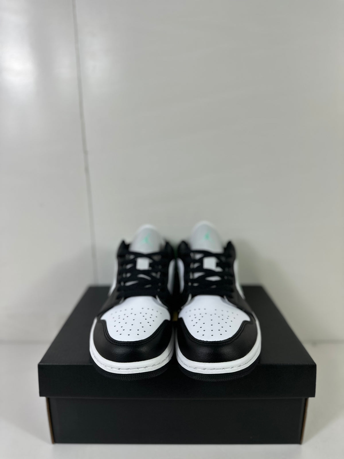 Front view of the pair showing perforated white toe boxes and black overlays.