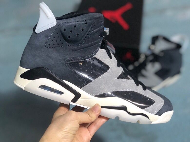 Side view of the black and grey high-top sneaker showing layered panels, perforated detailing, white midsole, and heel air unit.