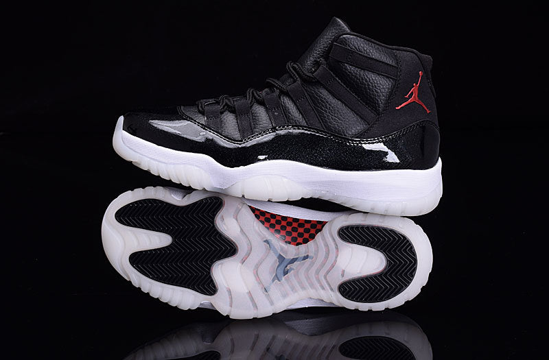 Side view of a black high-top sneaker positioned above its outsole, showing black traction areas and translucent white sections.