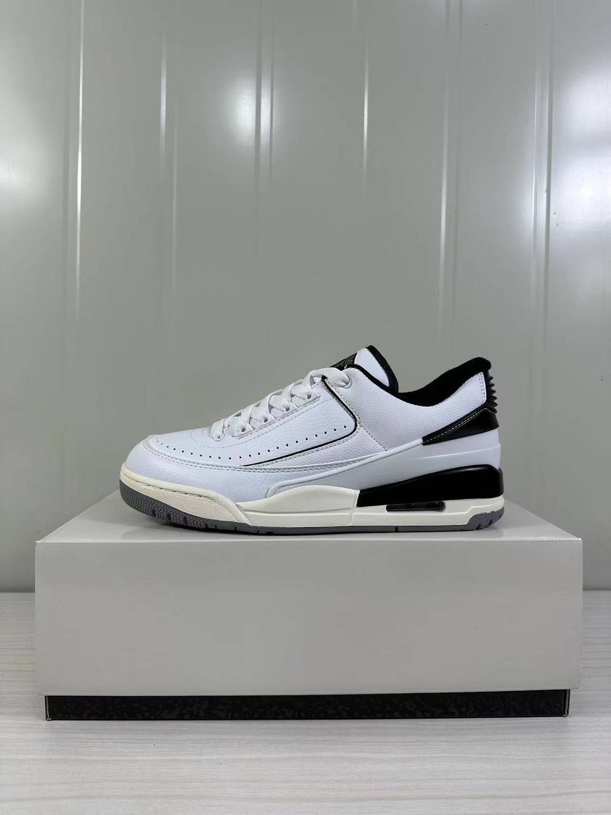 Side view showing the white upper, black collar and heel details, and gray rubber outsole.