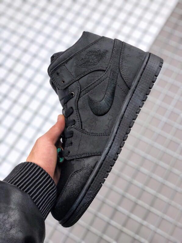 Side view of the black high-top sneaker showing the ankle panel, Swoosh, and outsole.