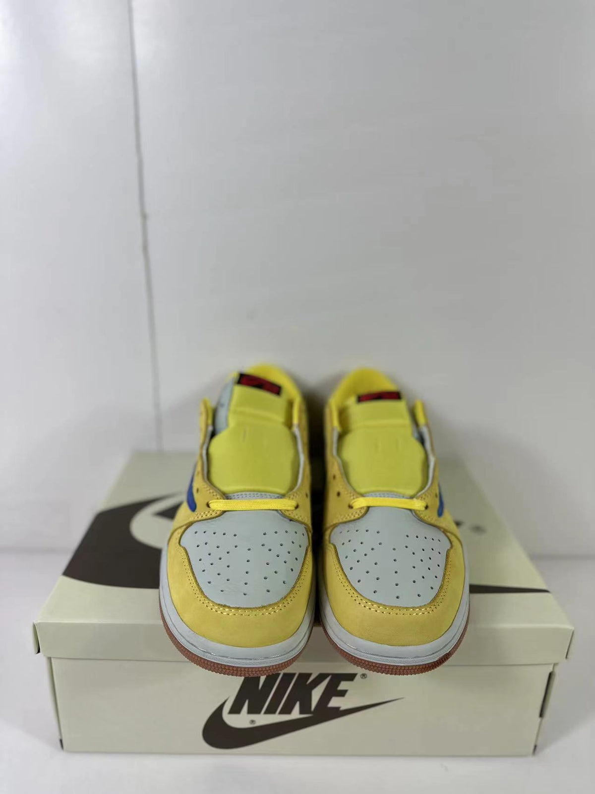 Top-front view showing the perforated light blue toe boxes and yellow lace areas.