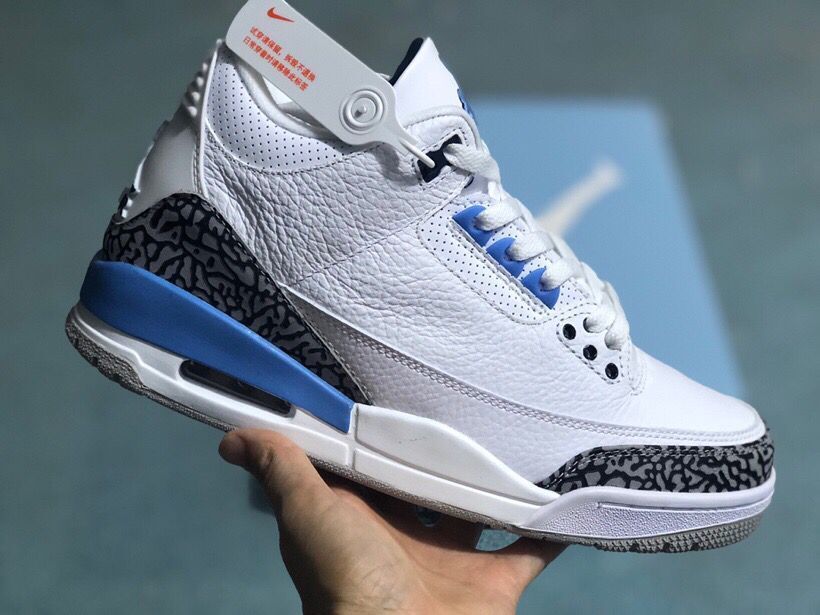 Angled side view of the white and blue sneaker