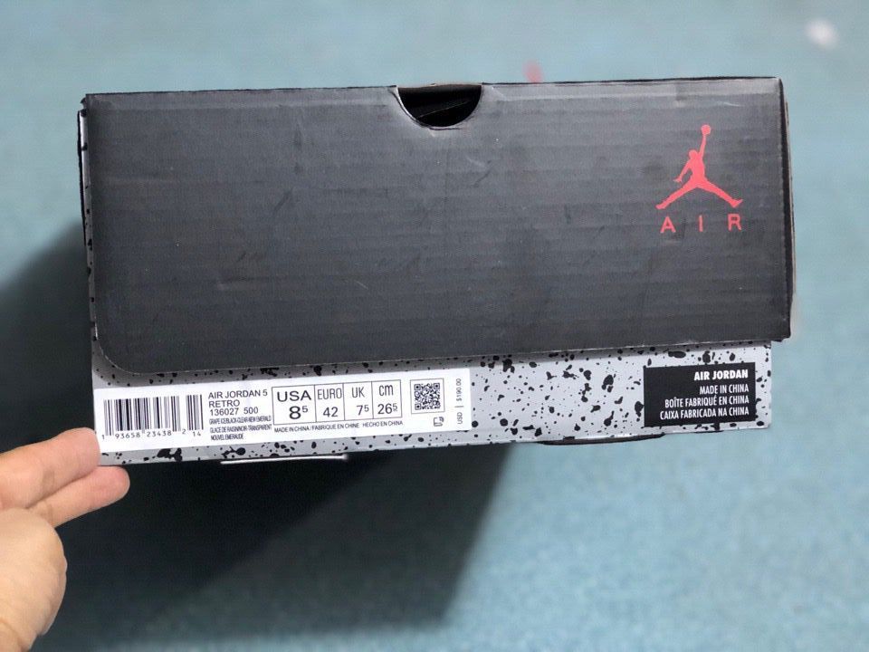 Black Air Jordan shoe box with a visible label showing Air Jordan 5 Retro, USA 8.5, EURO 42, UK 7.5, and CM 26.5.