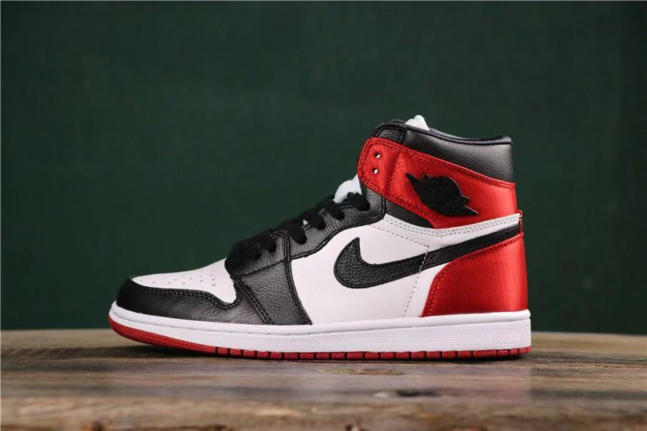 Opposite side profile showing the black toe overlay, white quarter panel, red heel, and red outsole.