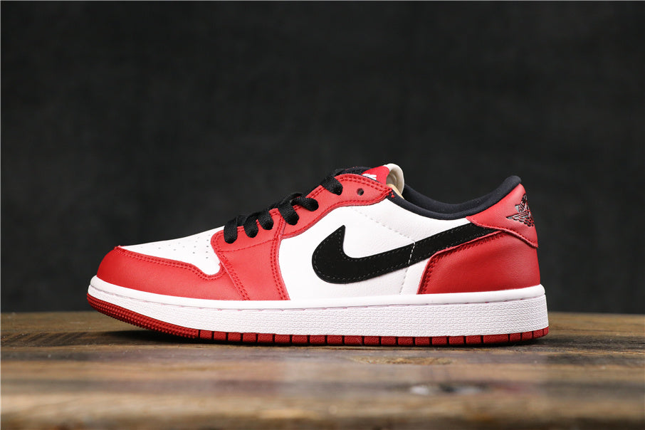 Side view of red, white, and black low-top Jordan-style sneakers with black laces, a black Swoosh, white midsole, and red outsole.