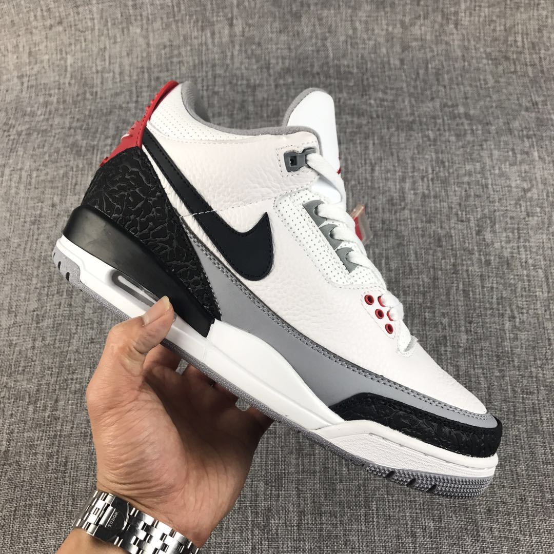 Side view showing the white upper, black Swoosh, grey midsole section, elephant-print overlays, and air window.