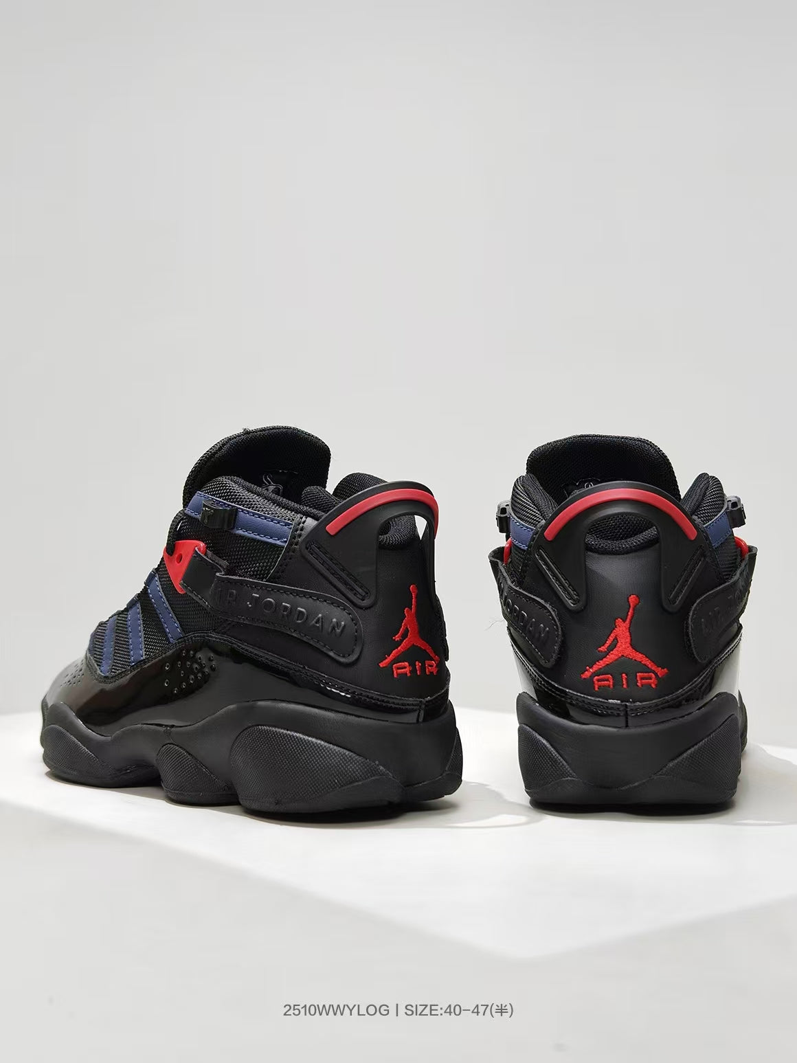 Rear view of black high-top sneakers with red Jordan branding and navy accents.