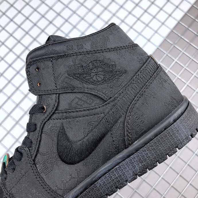 Close-up of the black sneaker side showing the tonal patterned upper, Swoosh, and ankle panel.