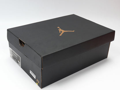 Black Jordan shoe box with a gold Jumpman logo and a visible size marking on the side.
