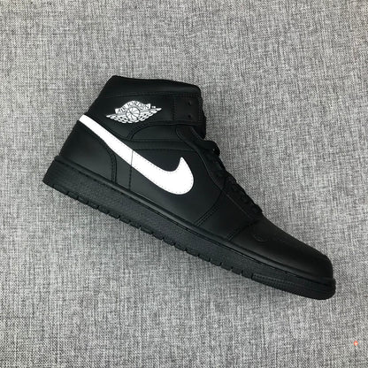 Angled top-side view of a black and white mid-top sneaker with visible collar branding.