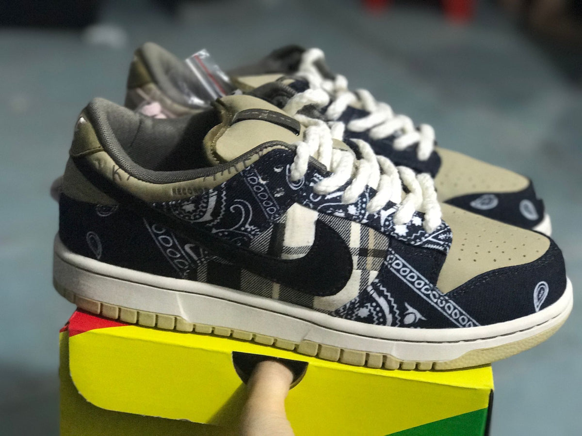 Side view of the low-top sneaker highlighting the dark Swoosh, patterned panels, light midsole, and beige outsole.