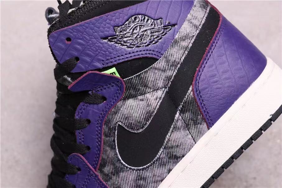 Close-up of the purple ankle panel, winged basketball emblem, black Swoosh, and patterned side panel.