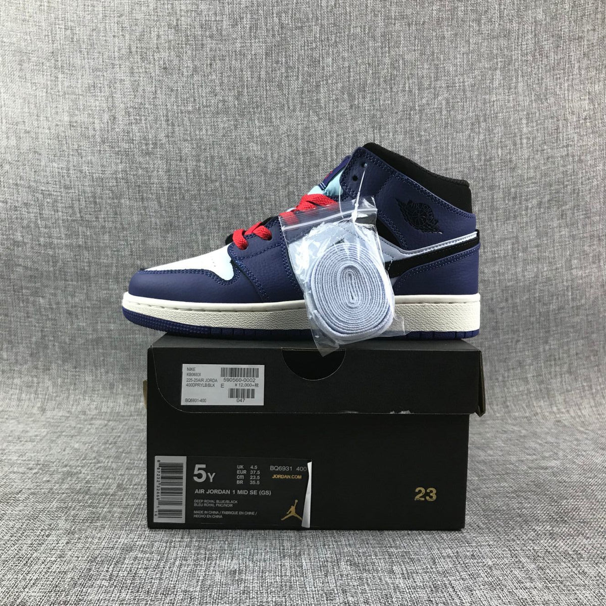 Sneaker and box display; the lower box label visibly states AIR JORDAN 1 MID SE (GS), EUR 37.5, and style code BQ6931-400.