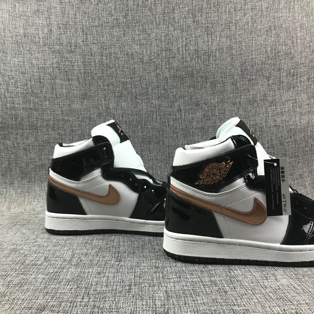 Pair of sneakers shown from the side with padded collars and attached product tags.