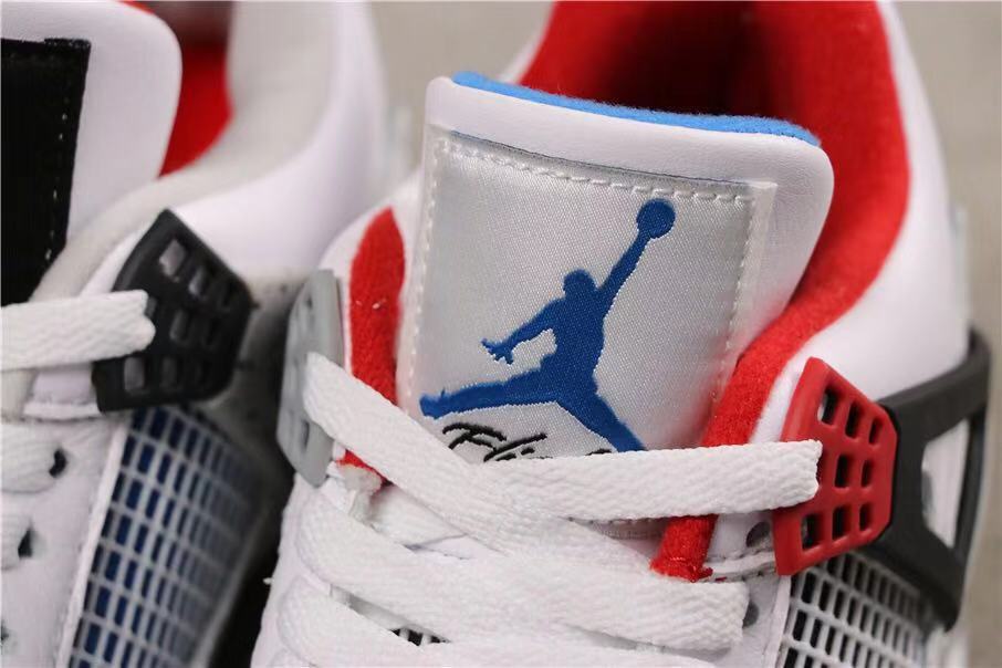 Close-up of a tongue label with blue Jumpman branding and red collar lining.