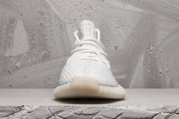 Front view of a white Yeezy 350 V2 sneaker with tonal laces and a rounded toe.