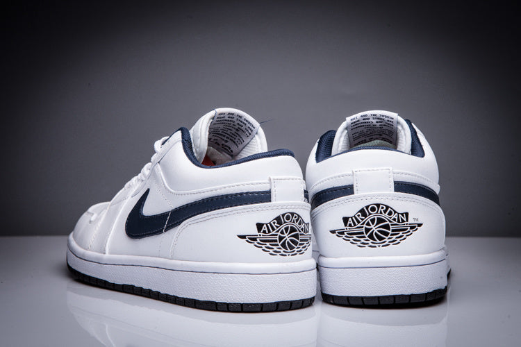Rear view of the pair showing the Air Jordan winged-ball heel logos and dark outsole edges.