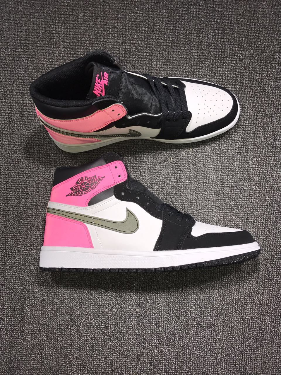Side profile showing the perforated white toe box, black forefoot overlays, pink collar and heel, and white midsole.