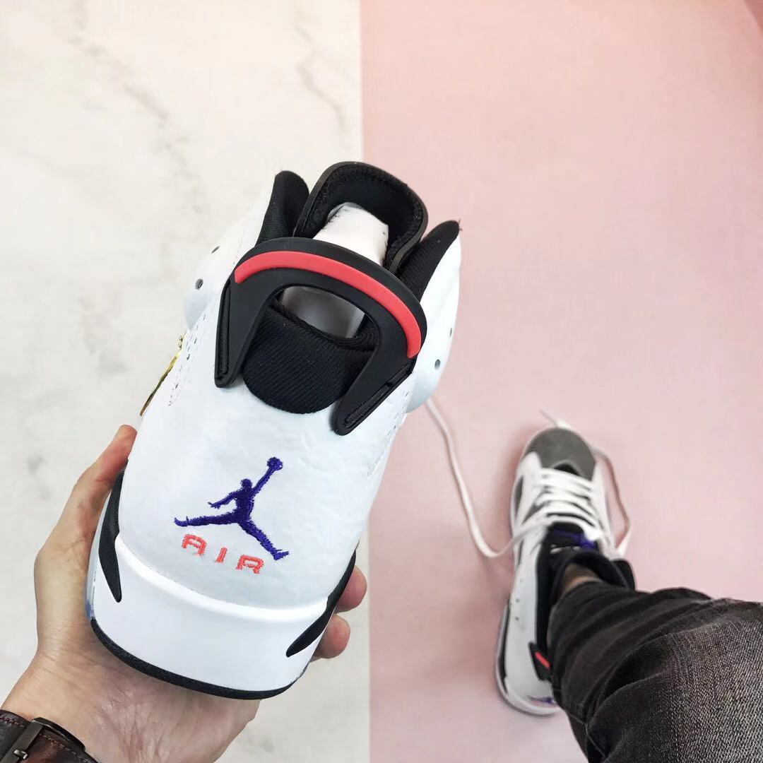 Rear view showing the black-and-red heel pull detail and purple Jumpman-style embroidery.