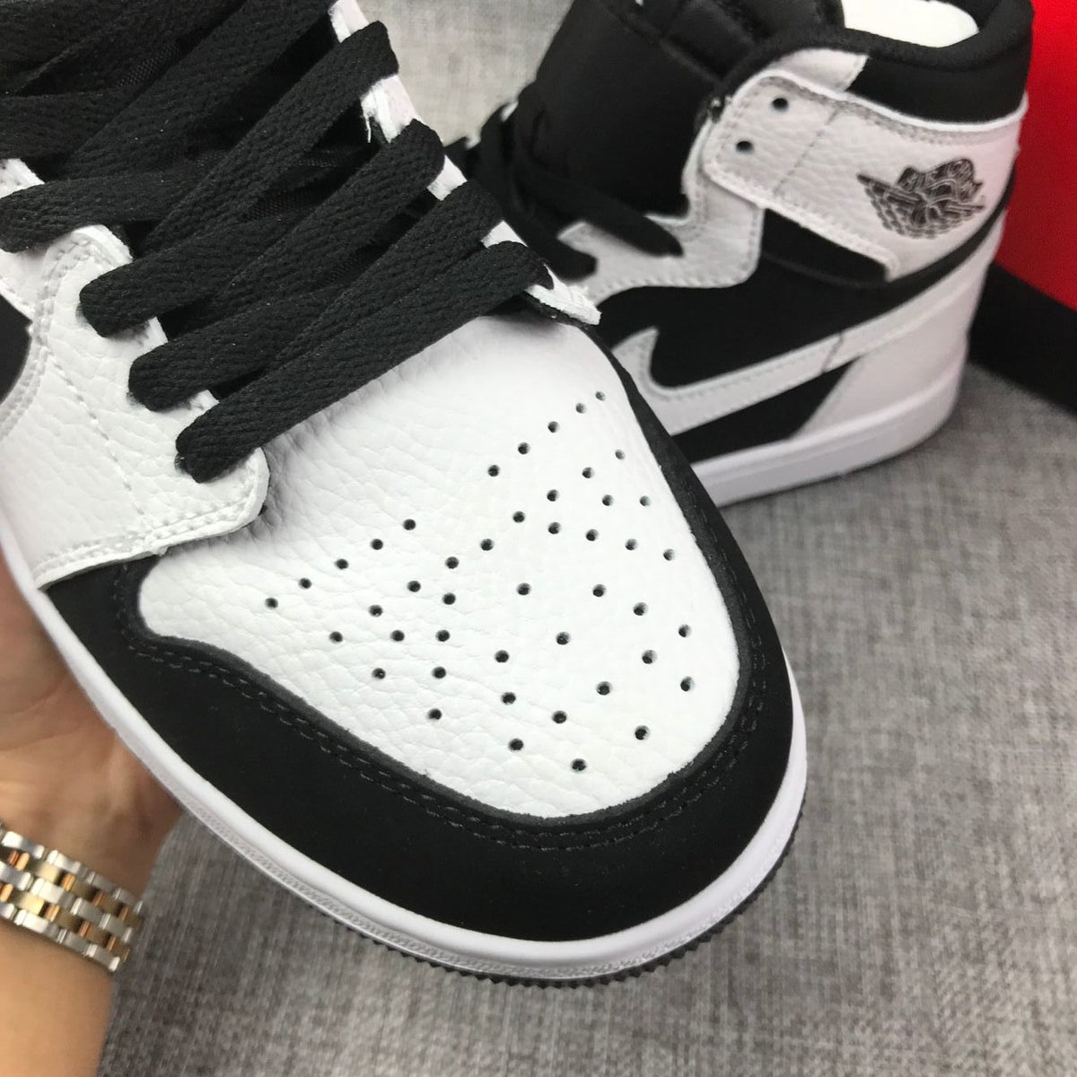 Close-up of the white perforated toe and black lace area