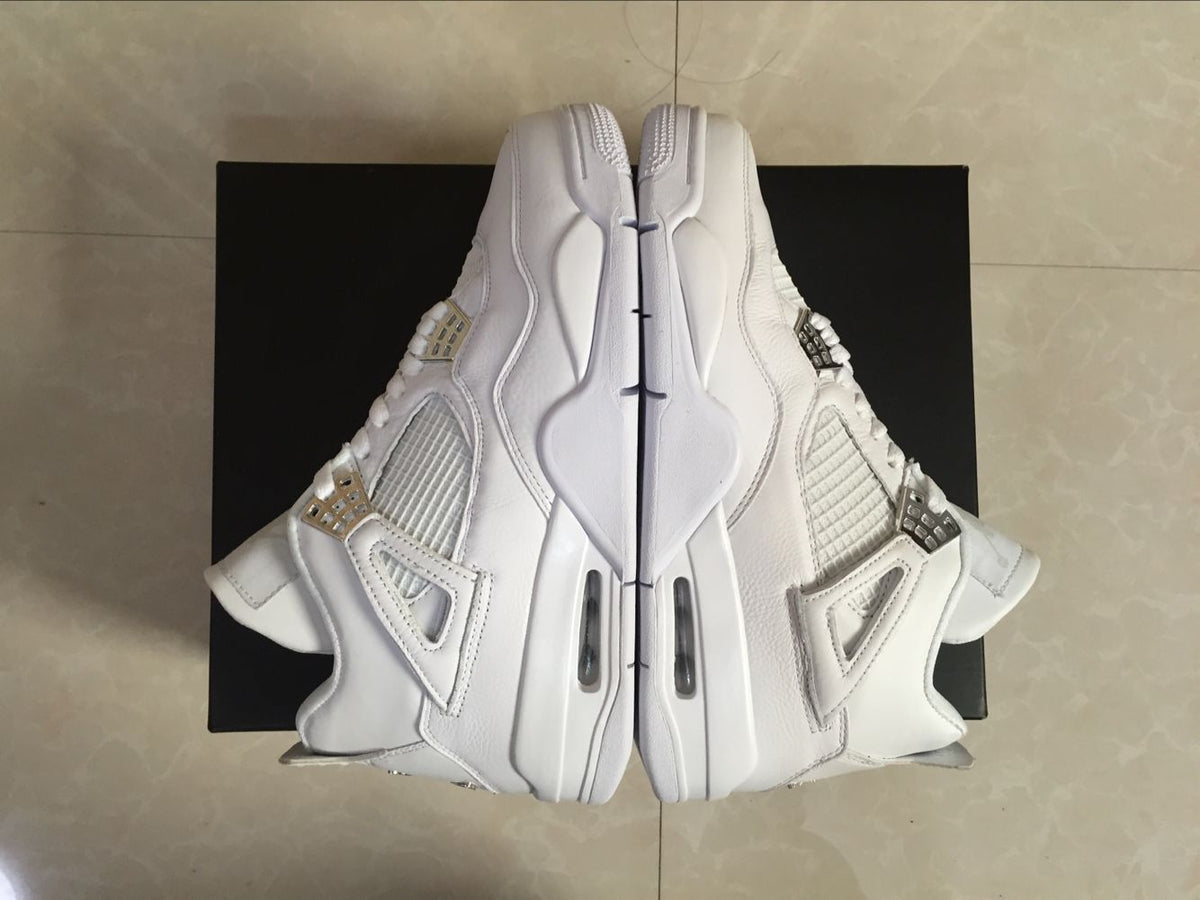 Top-down view of the pair showing the white uppers, side mesh panels, lace wings, and sculpted midsoles.
