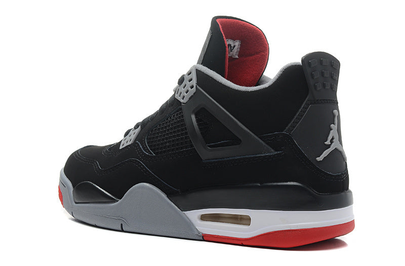 Side view of a black and red Jordan Air Jordan 4 Retro sneaker with grey midsole details.