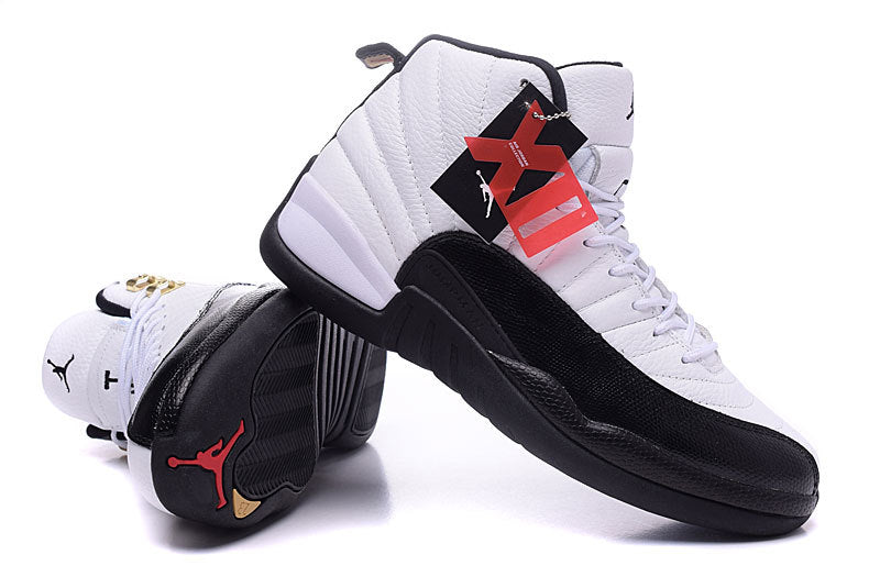 Angled view of the pair showing the black outsole, red Jordan outsole logo, yellow outsole accents, and attached hangtags.