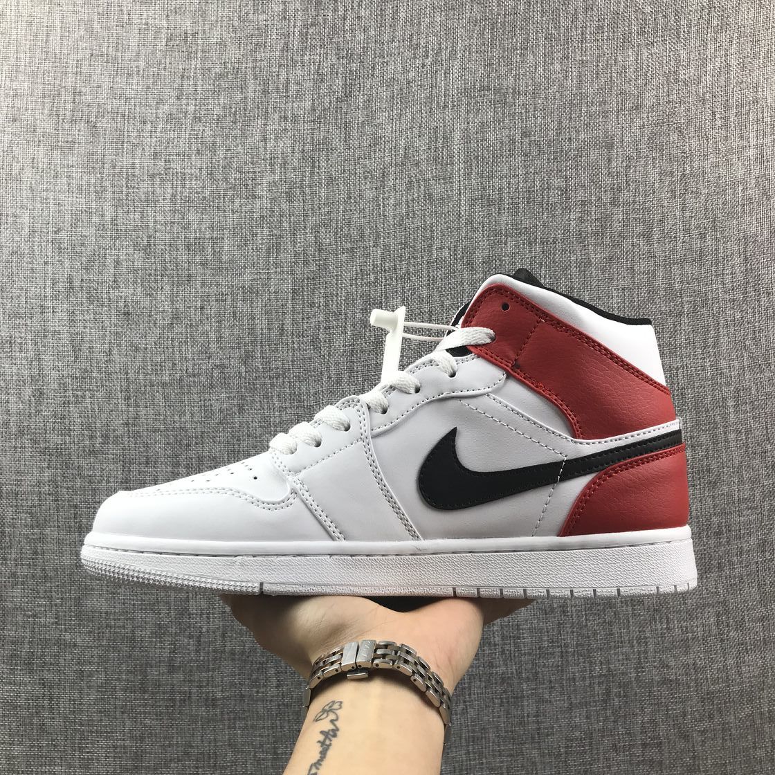 Lateral side view highlighting the red ankle and heel panels with black side branding.