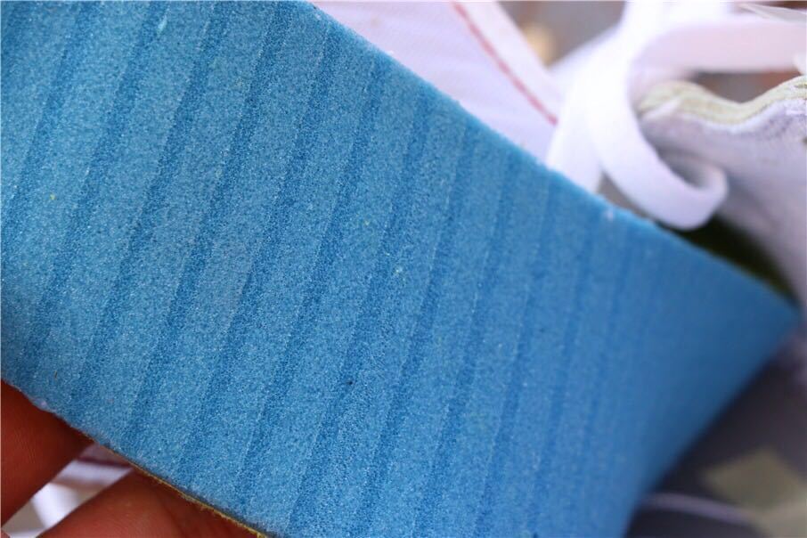 Close-up view of a blue textured shoe insert or packaging component.