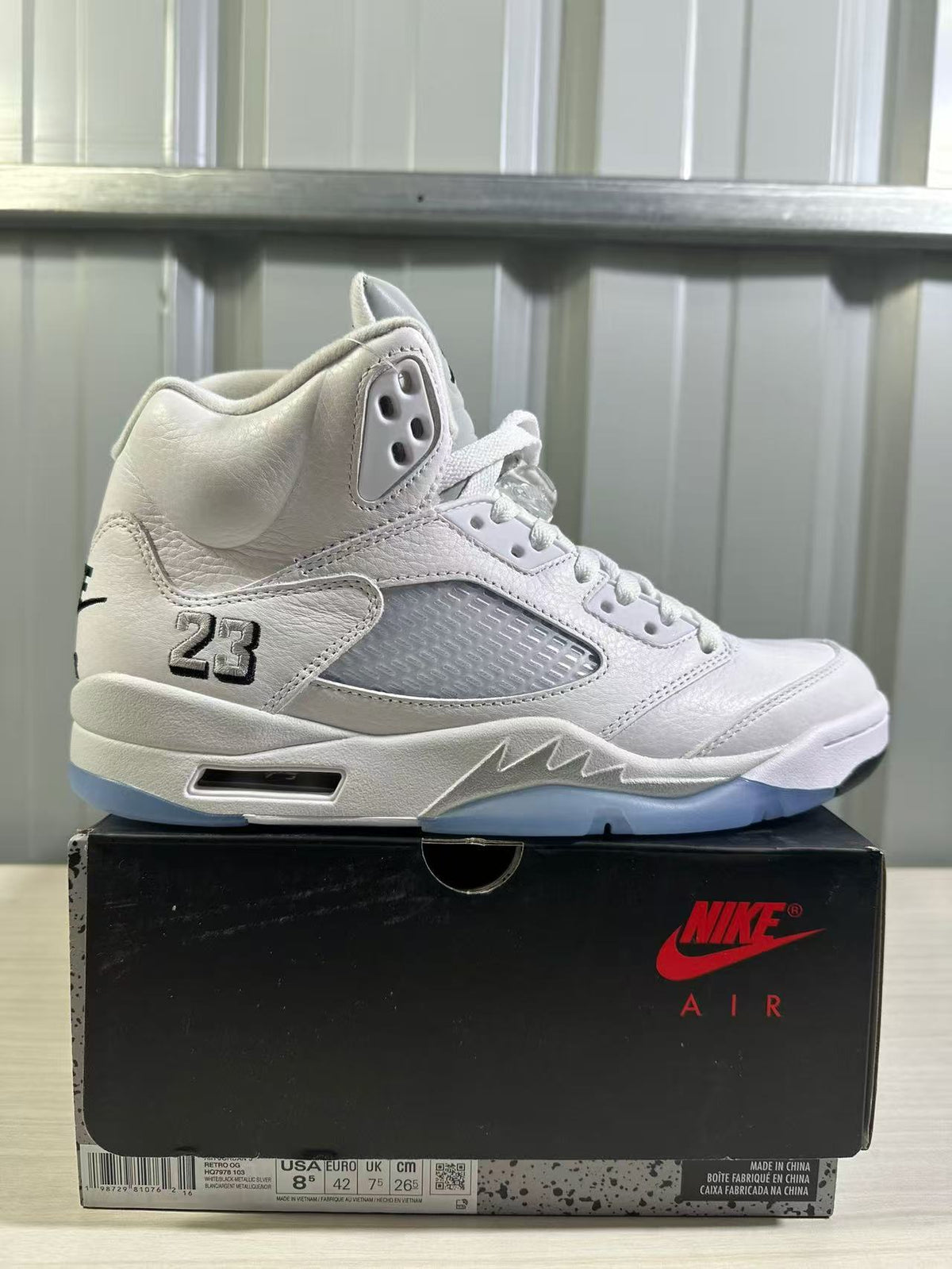 Single sneaker and shoe box showing the style code area and a label with Euro 42, USA 8.5, UK 7.5, and CM 26.
