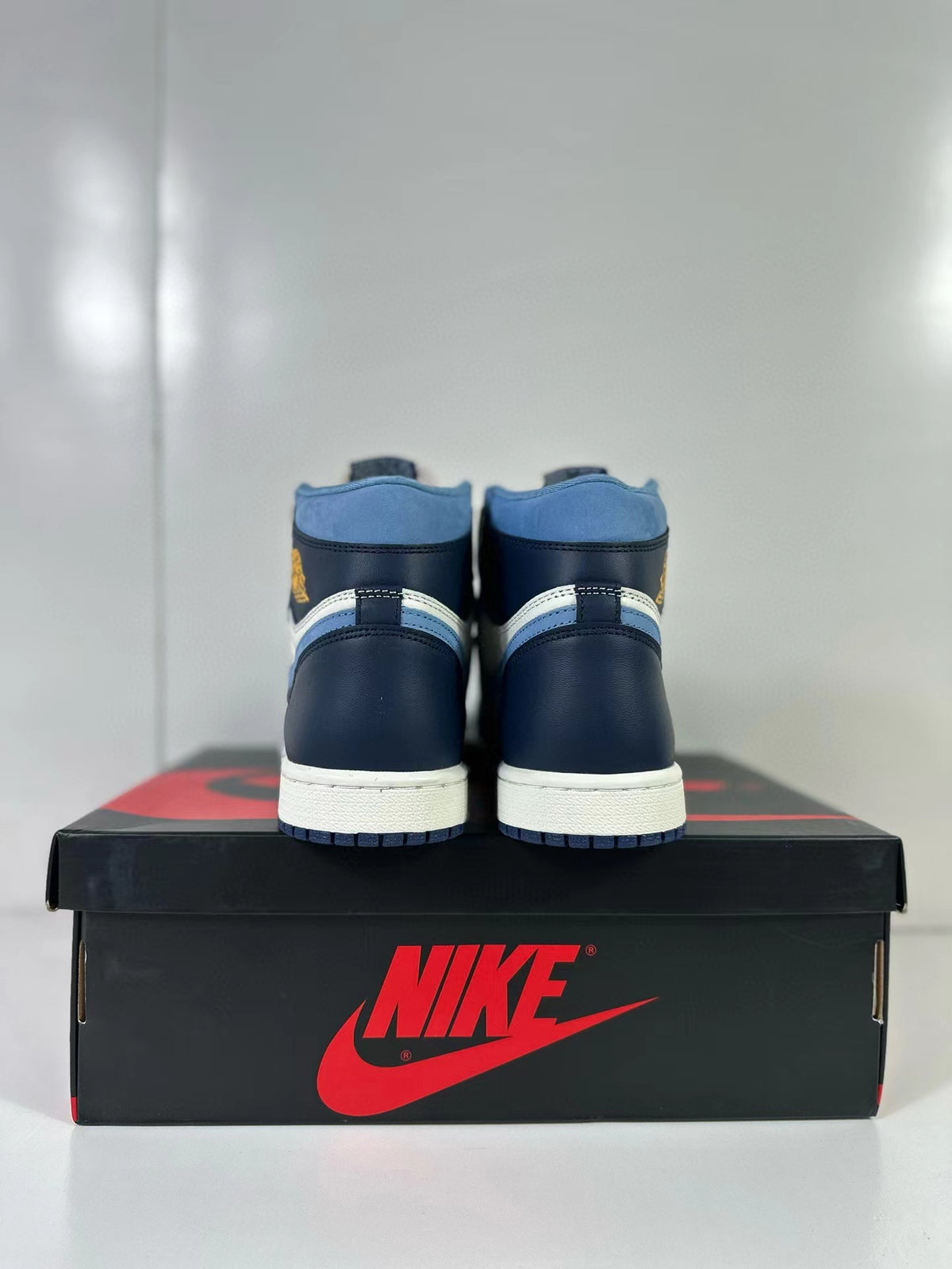 Rear view of the navy and blue heels of the high-top sneakers
