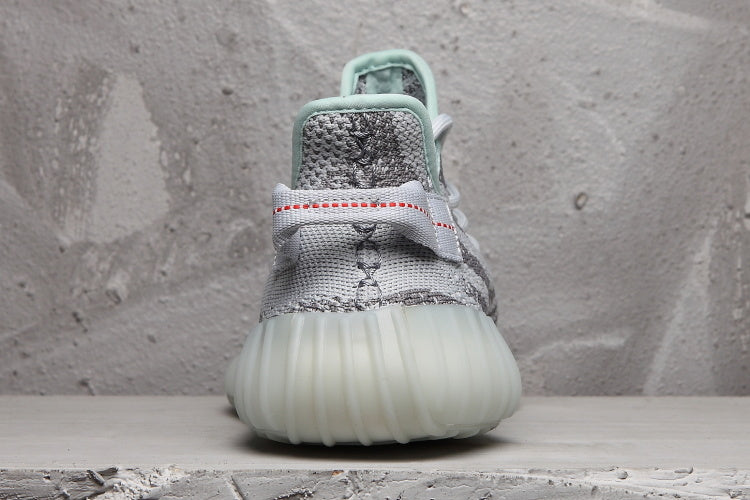 Rear view of the sneaker showing the heel pull tab, mint collar trim, and translucent sole.
