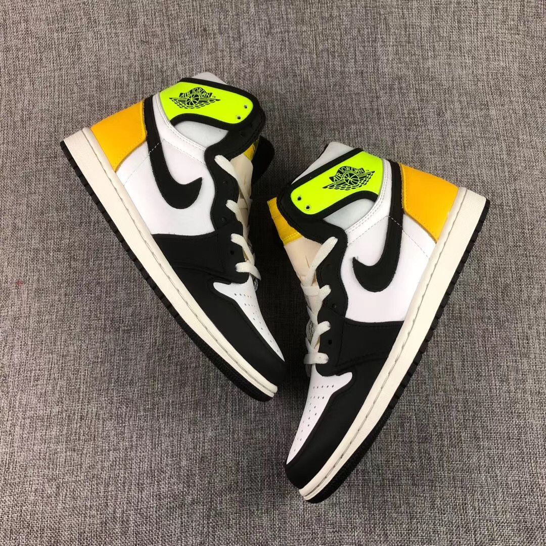 Overhead view of the pair of Volt Gold, black and white high-top sneakers.