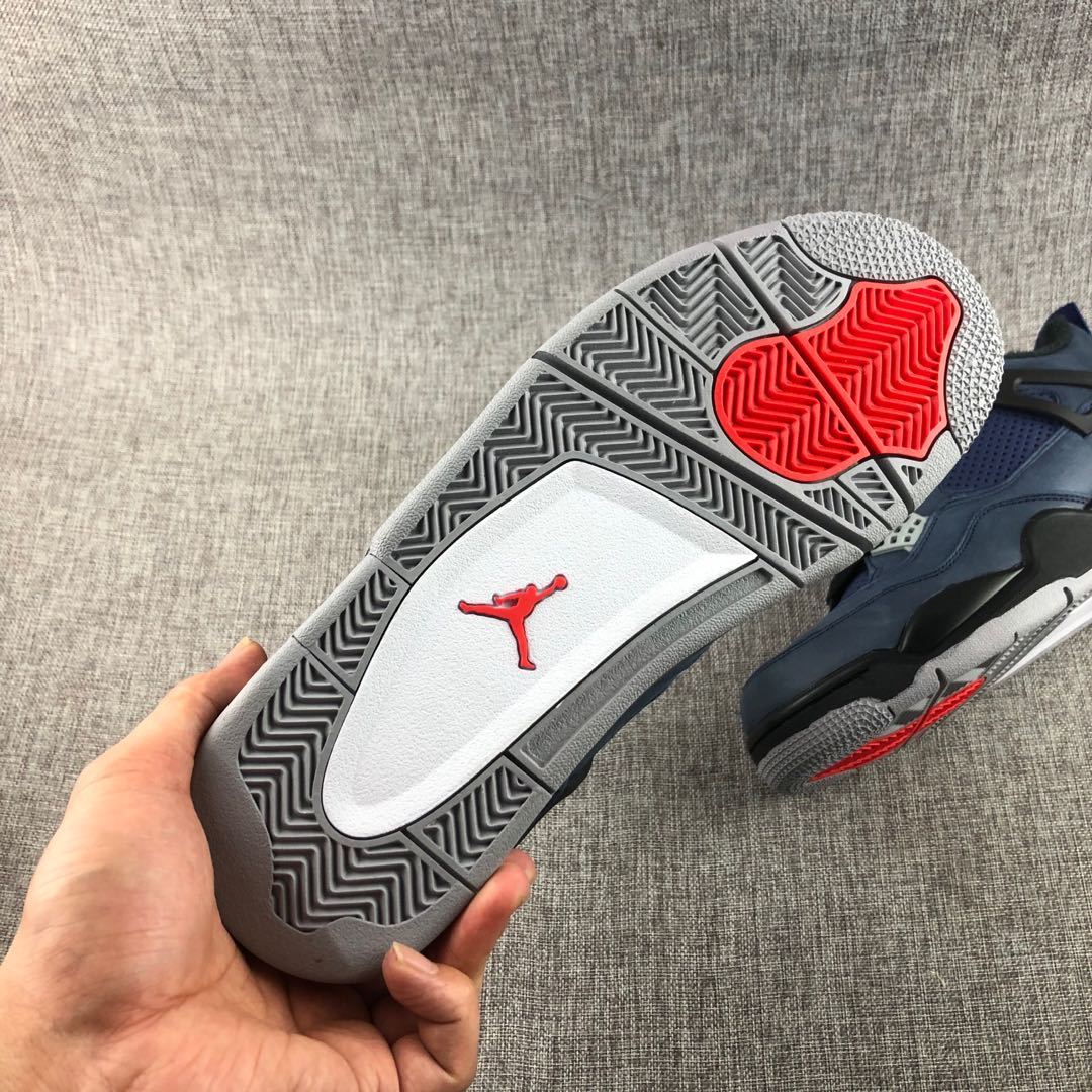 Close view of the patterned grey outsole with red traction sections and a red Jordan emblem.