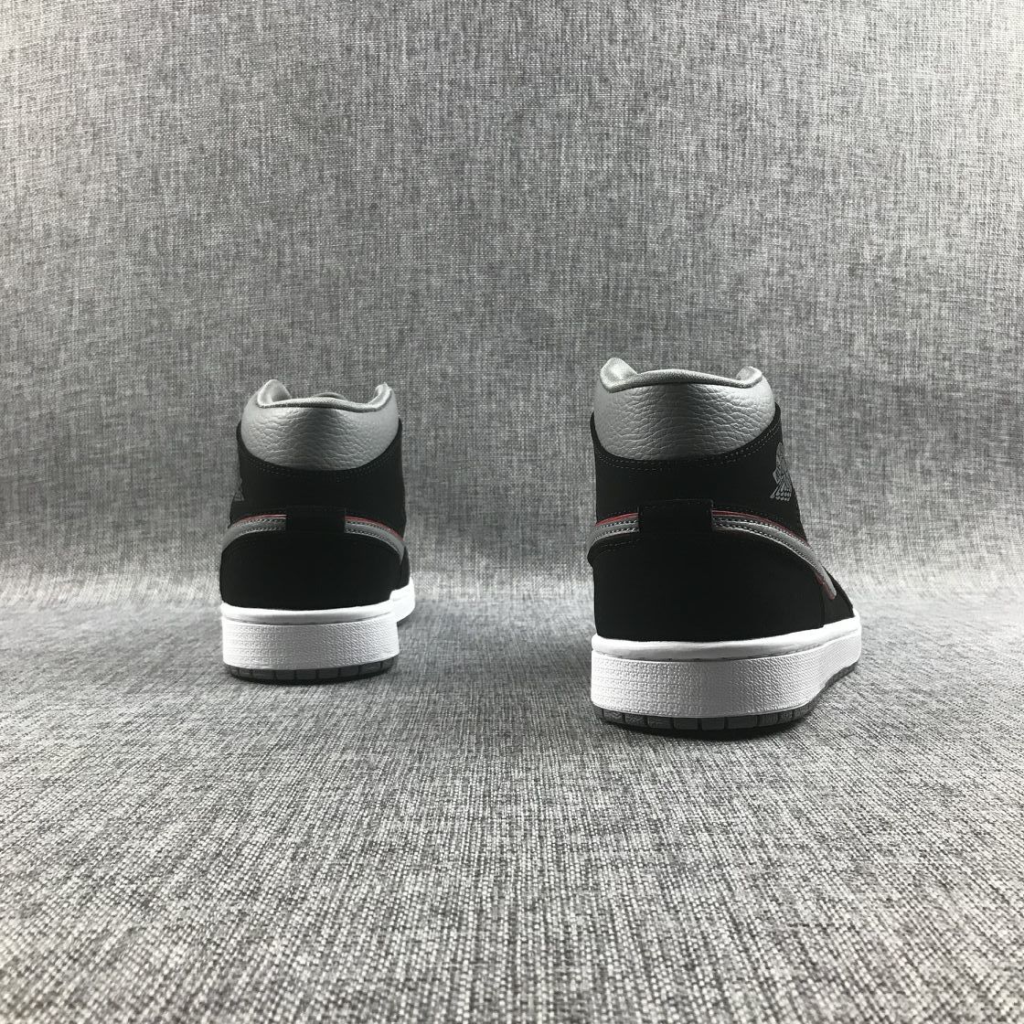 Rear view of both sneakers showing the black heel panels, grey collars and white midsoles.