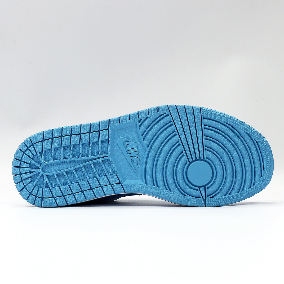 View of the blue rubber outsole with circular and segmented traction patterns.