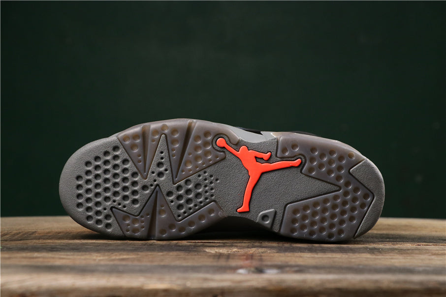 Bottom view showing the grey rubber outsole with a red Jumpman-style logo.