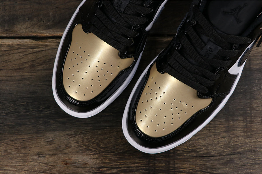 Top-down view showing metallic gold perforated toe panels, black overlays, and black laces.