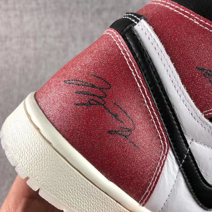 Detailed view of black printed markings on the red heel panel.