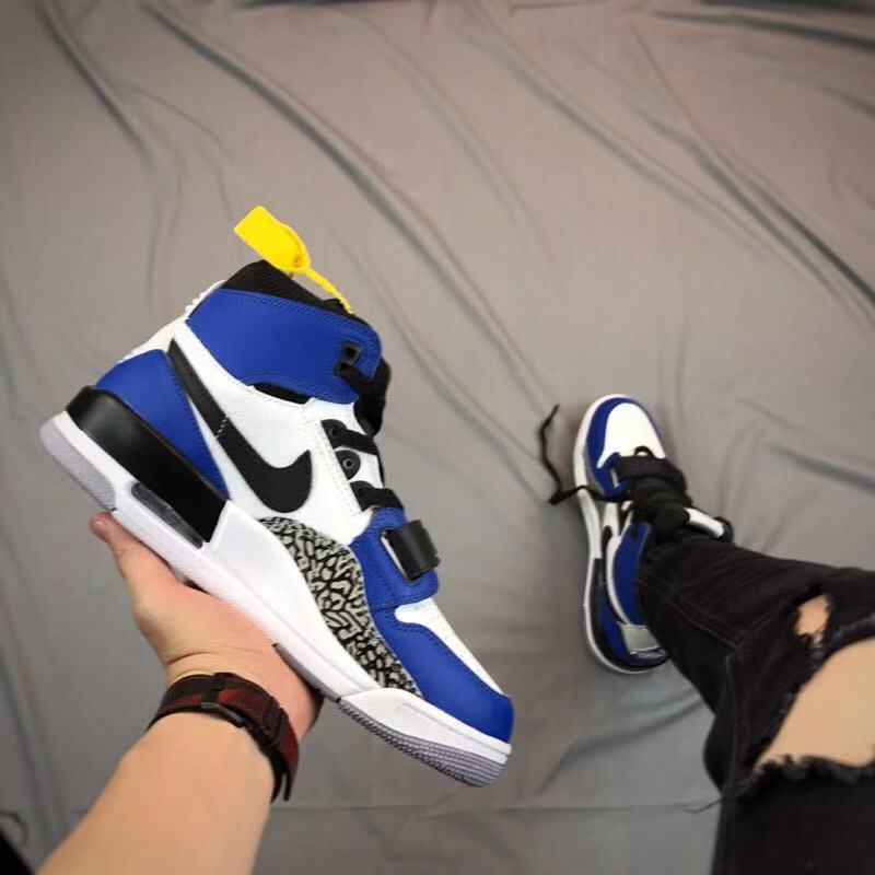 Angled side view highlighting the black Swoosh-style detail, elephant-print panel, strap, and layered sole.