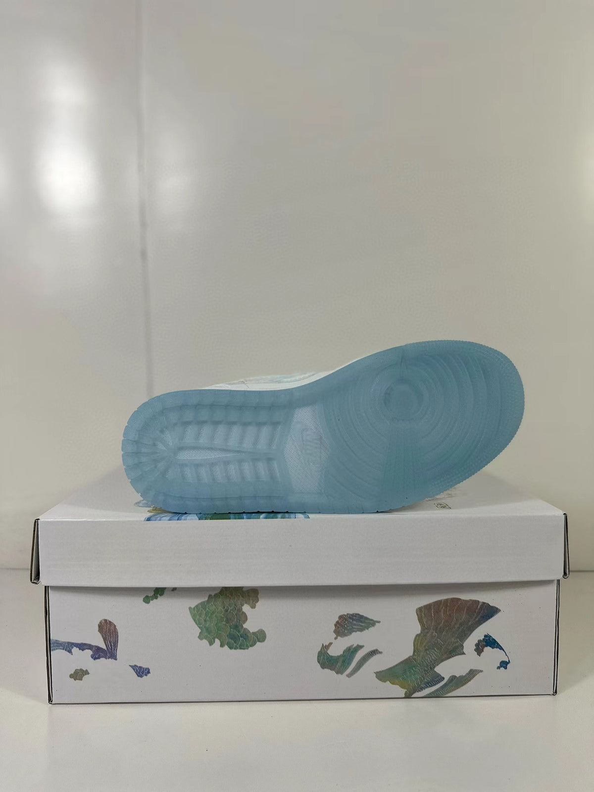 Translucent blue outsole of a low-top sneaker shown from below.