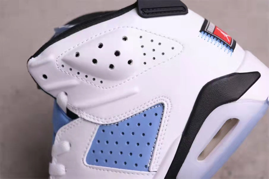 Close-up of the perforated white and University Blue side panels, black trim, and heel cushioning area.