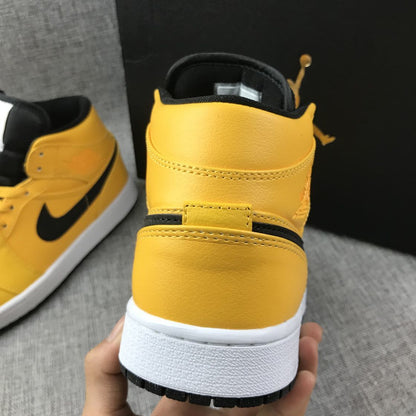 Rear view showing the yellow padded collar, black lining, and white midsole.