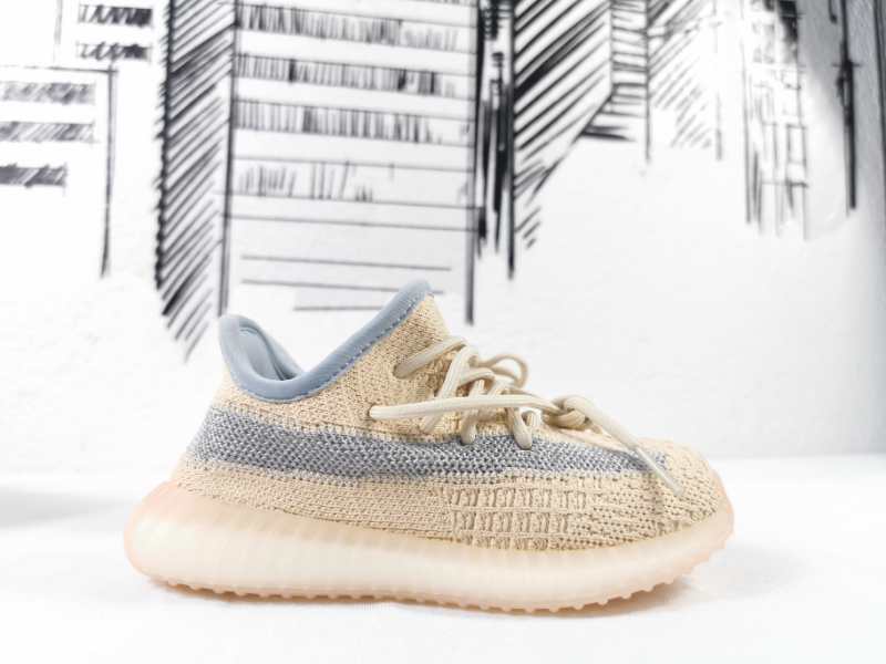 Side profile of the linen-yellow low-top sneaker with matching laces and a gray stripe.
