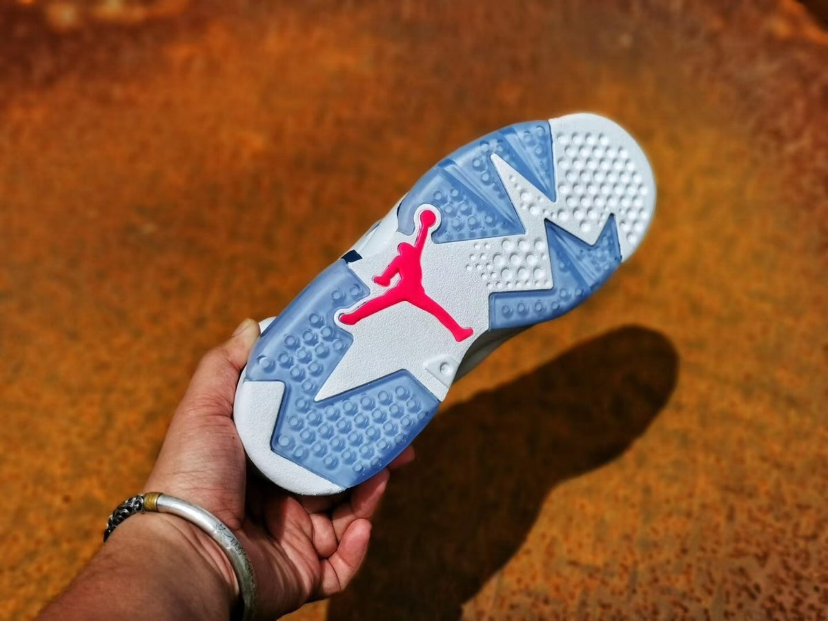 Outsole view showing a white and translucent blue traction pattern with pink Jordan branding.