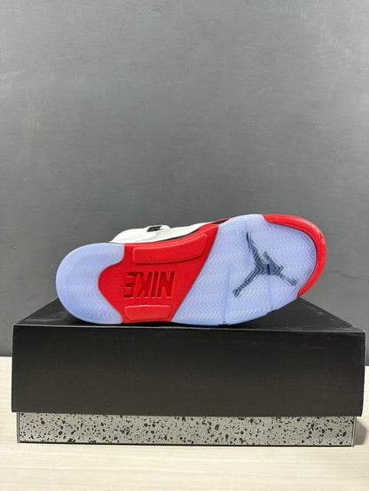 Outsole view showing translucent rubber sections, red traction areas, herringbone tread, and a central Jordan design.
