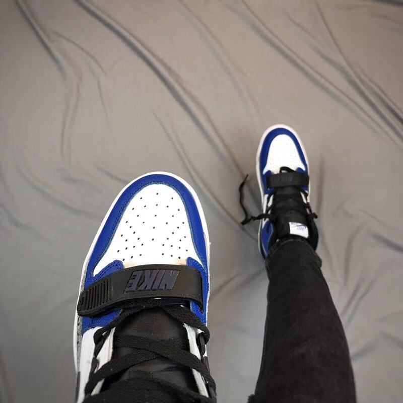 Top view showing the perforated white toe box, blue overlays, black laces, and midfoot strap.