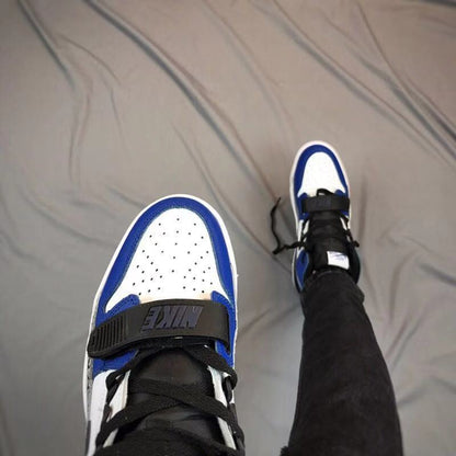 Top view showing the perforated white toe box, blue overlays, black laces, and midfoot strap.