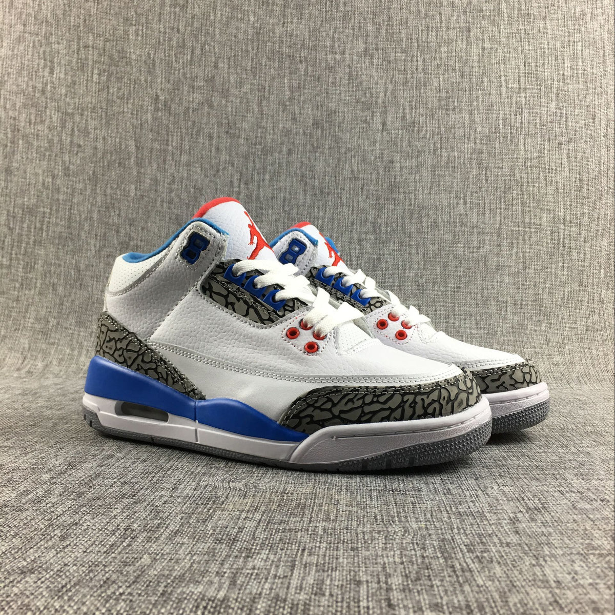 Pair of white Air Jordan 3 Retro sneakers shown from the front and side.